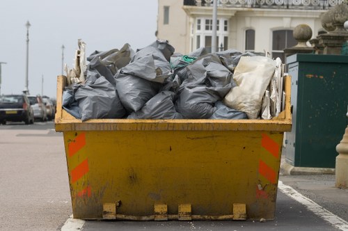 Builders removing construction waste in Heston site