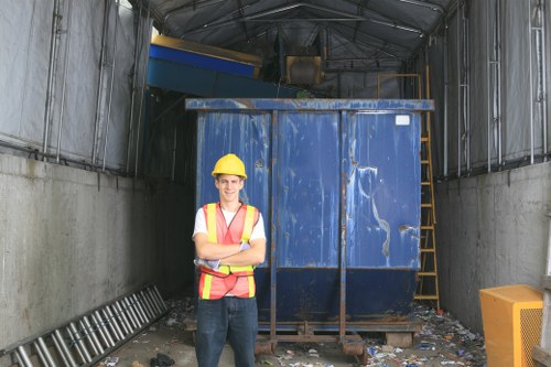 Workers loading rubbish into a van in a residential Heston area
